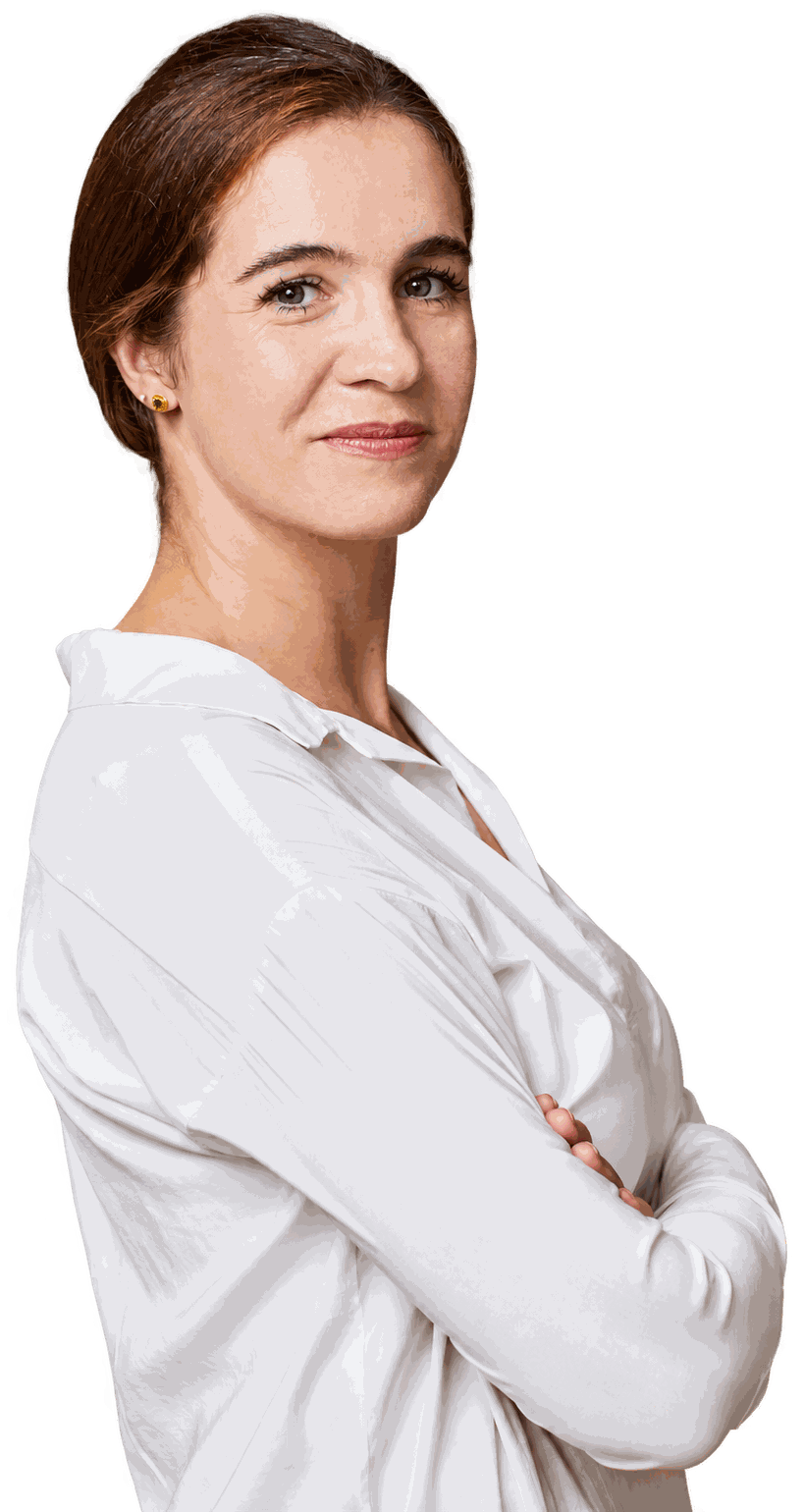 Sabine Karunanithy in a white blouse, arms crossed, looking over her shoulder